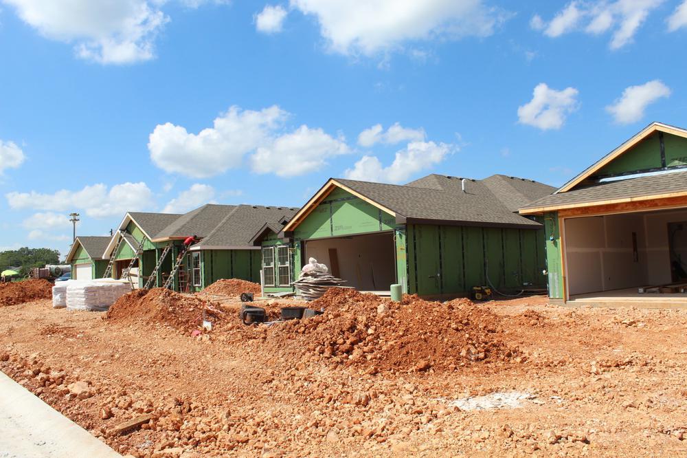 new homes, construction zone, blue skies and red clay dirt