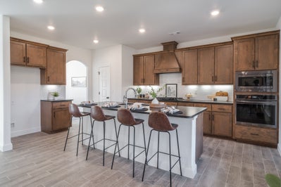 Spacious kitchen featuring luxury stained cabinets