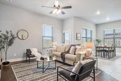 Warm welcoming home layout with neutral couch and gray chairs