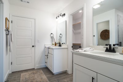 Double vanity master bathroom with convenient access to large closet