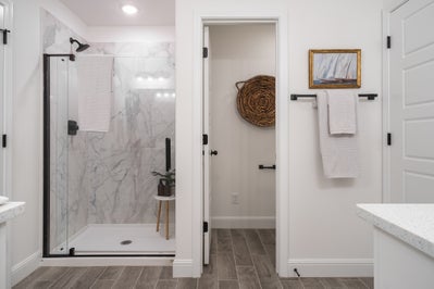 An elegantly painted white bathroom with modern shower design