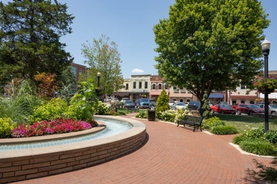 Downtown Bentonville, Arkansas square with garden and foundation as the central attraction with local businesses in the background